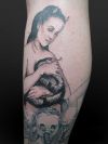 girl with snake tattoo on leg